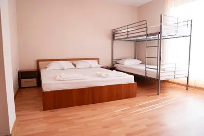 a bedroom with a bunk bed and a ladder at Къща за гости Далинда in Byala
