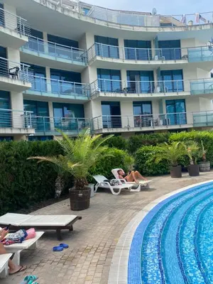 a hotel with a swimming pool and a building at Отличен Двустаен Слънчев бряг до 4 души 304 in Sunny Beach