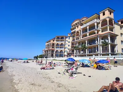 a group of people on the beach in front of a hotel at Elenite Sea View Apartments in Elenite