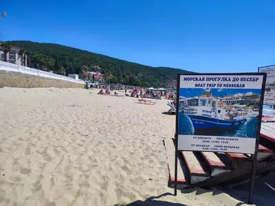 a sign on a beach with a boat on it at Elenite Sea View Apartments in Elenite
