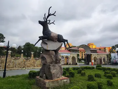 a statue of a deer on top of a rock at Elenite Sea View Apartments in Elenite