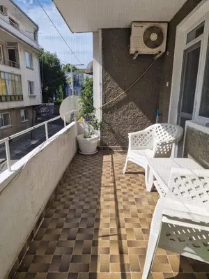 a balcony with two white benches and a basketball hoop at Апартамент Бижу М in Pomorie