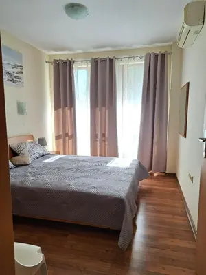 a bedroom with a bed and a large window at Lidda Relax in Oasis Beach Kamchia in Bliznatsi