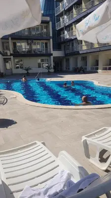 a swimming pool with some people in the water at Прекрасно студио in Sunny Beach