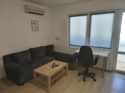a living room with a couch and a desk and a chair at Васил Левски 61 in Burgas City