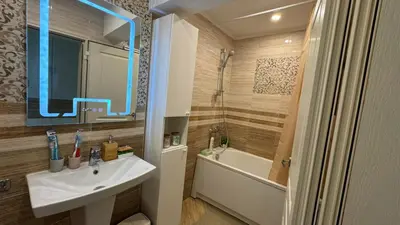 a bathroom with a sink and a shower and a tub at Апартамент Панорама Лазур in Burgas City