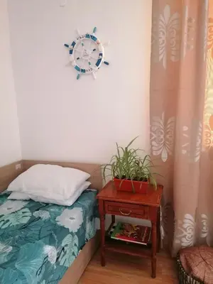 a bedroom with a bed and a clock on the wall at Апартаменти Захариеви 4 in Byala