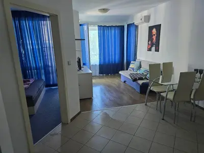 a living room with a couch and a table and chairs at POMORIE Blue Bay in Pomorie