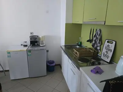 a small kitchen with a sink and a refrigerator at POMORIE Blue Bay in Pomorie
