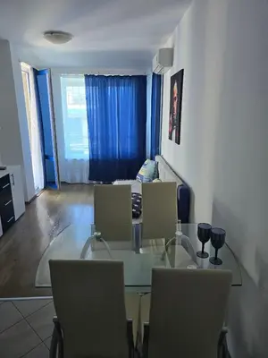 a living room with a glass table and chairs at POMORIE Blue Bay in Pomorie