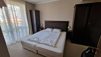 a bedroom with a bed and a flat screen tv at Apartment in Royal Beach Barcelo in Sunny Beach