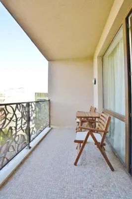 a wooden bench sitting on a balcony with a table at Apartment in Royal Beach Barcelo in Sunny Beach