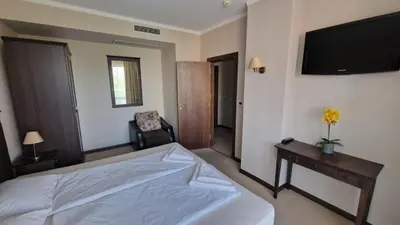 a bedroom with a bed and a tv on the wall at Apartment in Royal Beach Barcelo in Sunny Beach