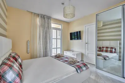 a bedroom with a bed with two teddy bears on it at 2BD Flat with Balcony in Flores Garden Complex by Flat Mаnаger in Chernomorets