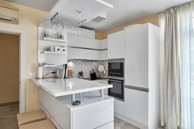 a white kitchen with white cabinets and appliances at 2BD Flat with Balcony in Flores Garden Complex by Flat Mаnаger in Chernomorets