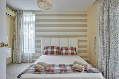 a bedroom with a bed with two pillows on it at 2BD Flat with Balcony in Flores Garden Complex by Flat Mаnаger in Chernomorets