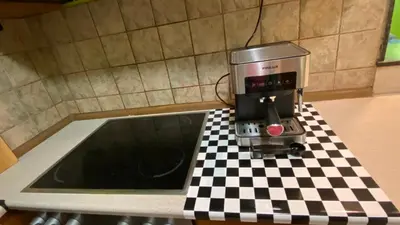 a coffee maker on a checkered counter in a kitchen at Aurora Sea Breeze in Burgas City