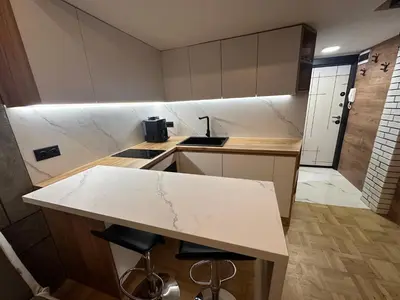 a kitchen with a white counter top in a room at Studio Lazur in Burgas City