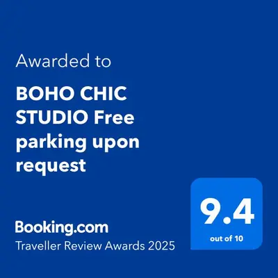 a blue sign with the text awarded to beta chi studio free parking upon request at BOHO CHIC STUDIO Free parking upon request in Varna City