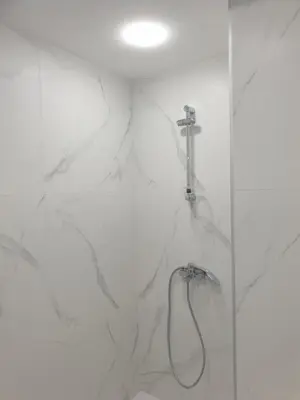 a bathroom with a shower with a faucet at BOHO CHIC STUDIO Free parking upon request in Varna City