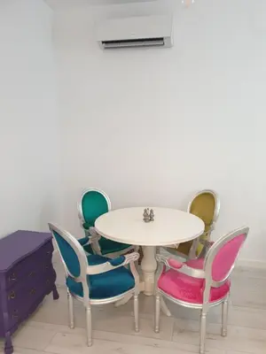 a table and chairs in a room with a table at BOHO CHIC STUDIO Free parking upon request in Varna City