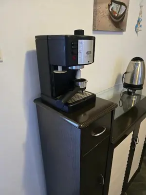 a coffee maker on top of a wooden table at POMORIE Luxury Appartment in Pomorie