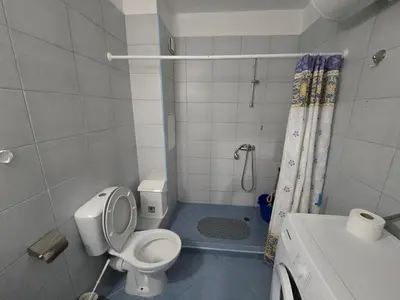 a small bathroom with a toilet and a shower at POMORIE Luxury Appartment in Pomorie