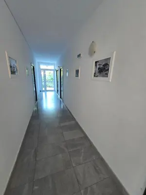 an empty hallway with white walls and a tile floor at POMORIE Luxury Appartment in Pomorie