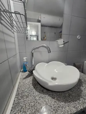 a bathroom with a white sink and a mirror at POMORIE Luxury Appartment in Pomorie