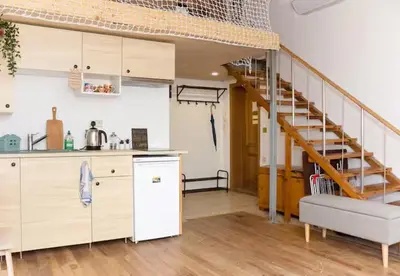 a kitchen with a staircase in a room at Blue Sea Side Studio in Varna City