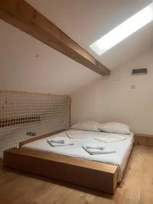 a bedroom with a large bed in a room at Blue Sea Side Studio in Varna City