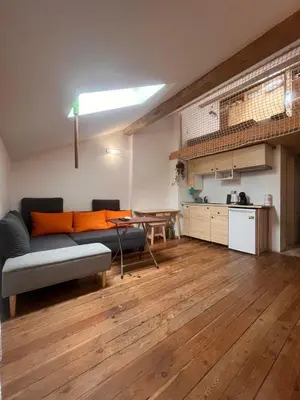 a living room with a couch and a table at Blue Sea Side Studio in Varna City