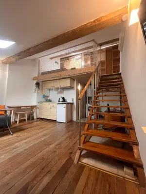 a large room with a staircase and a kitchen at Blue Sea Side Studio in Varna City