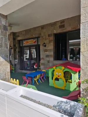 a childrens play area with a toy house at Студио в Затворен Комплекс Blue in Sozopol