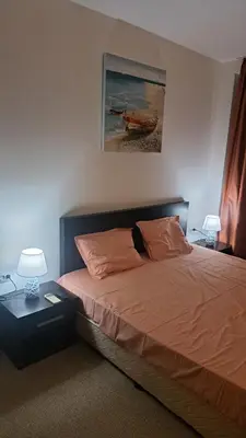 a bedroom with a bed with two pillows on it at Holidays Apartment Atlantis Sarafovo in Burgas City