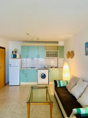 a living room with a couch and a kitchen at Cozy apartment in Kambani 1 in Sveti Vlas