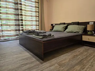 a large bed in a room with a large window at Ах, морето !!! in Tsarevo