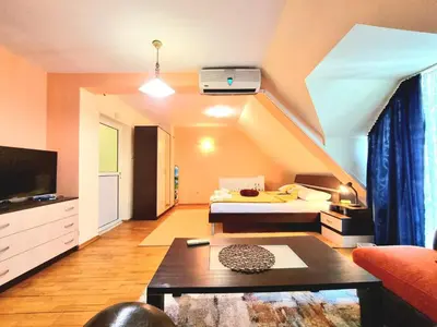 a living room with a bed and a couch at Two-Floor Sunny Apartment in City Centre in Burgas City