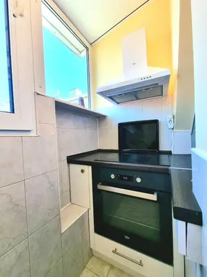 a small kitchen with a stove and a microwave at Two-Floor Sunny Apartment in City Centre in Burgas City