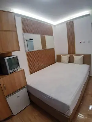 a bedroom with a large bed and a television at STUDIO MORARo in Varna City