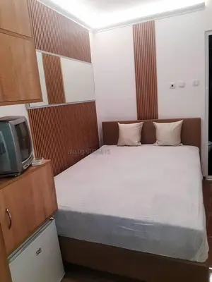 a small bedroom with a bed and a tv at STUDIO MORARo in Varna City