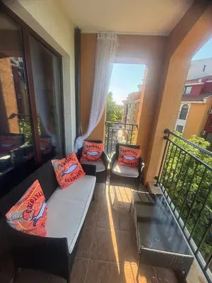 a living room with a couch and a balcony at Marina Cape Sky View Lux Apartment in Aheloy in Aheloy