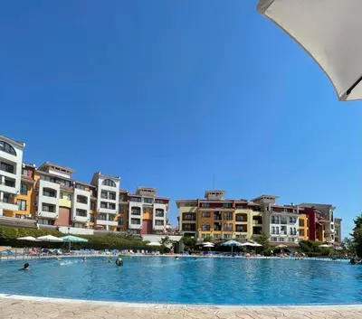 a pool with people in it with buildings in the background at Marina Cape Sky View Lux Apartment in Aheloy in Aheloy