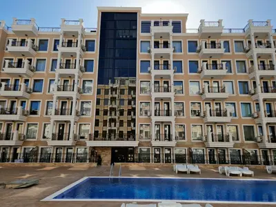 an apartment building with a pool in front of it at Polarstar 205A am Meer Sveti Vlas in Sveti Vlas