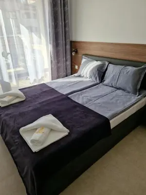 a bed with two towels sitting on top of it at Polarstar 205A am Meer Sveti Vlas in Sveti Vlas