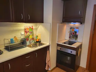 a kitchen with a sink and a stove at Apartment Sunrise in Obzor