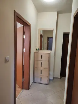 an empty room with a dresser and a mirror at Apartment Sunrise in Obzor