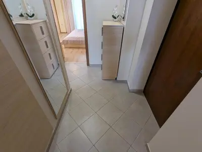 a stairway with a mirror and a hallway with a room at Apartment Sunrise in Obzor