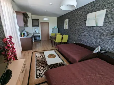 a living room with a couch and a table at Apartment Sunrise in Obzor