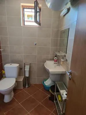 a bathroom with a toilet and a sink at Apartment Sunrise in Obzor